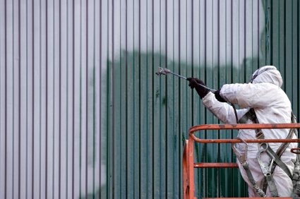 Commercial Painting - painter painting side of factory